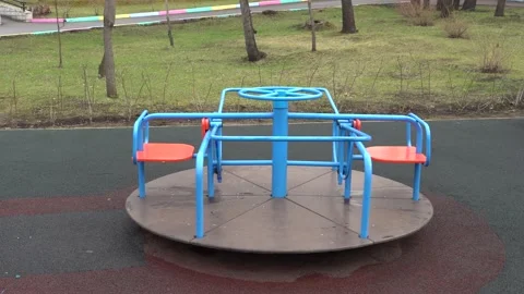 Children's rotating carousel in the park. Spins without people Stock Footage 153315955