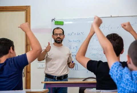 Children's in school so excited with their teacher and raising their hands .. Stock Photos