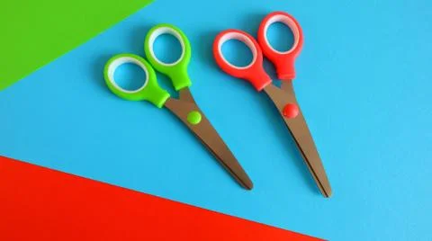 Children's scissors for needlework on a bright background from colored paper Foto stock