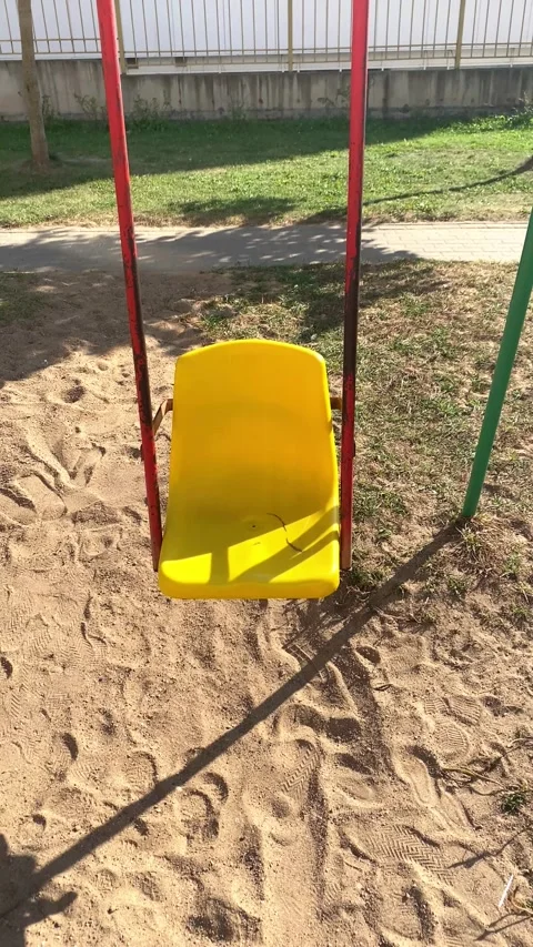 Children's single-seater swing. Children's playground. Summer. Vertical video  Stock Footage 284008024