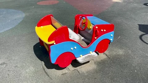 Children's spring swing in the shape of a car in the playground Stock Footage 158832179