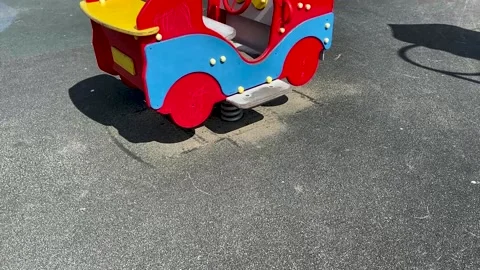 Children's spring swing in the shape of a car in the playground Stock Footage 158927946