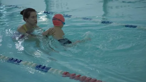 Childrens Swimming Lessons with an Instructor in a Pool Setting for All Skill Stock Footage 317372311