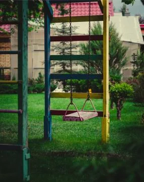 Children's swing on a chain Stock Photos