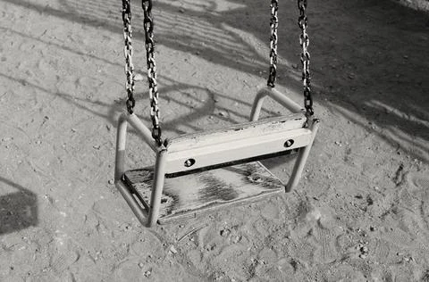 Children's swing is empty on the playground Stock Photos
