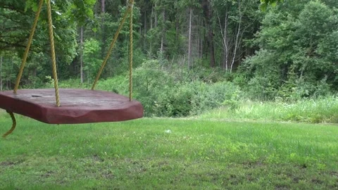 Children's swing with no-one to play Stock Footage 239701691