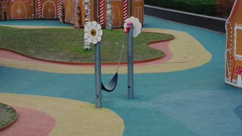 The children's swing swings up and down alone. Stock Footage 261583449