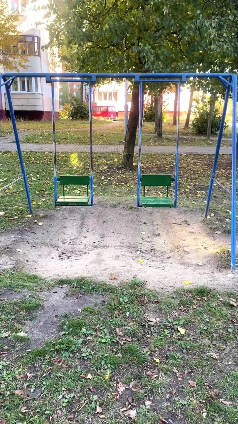 Children's swings on the playground. Vertical video Stock Footage 287943353