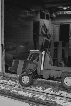 Children's toy on a broken window Stock Photos