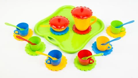 Children's toy multi-colored plastic tableware on a white background. Foto stock