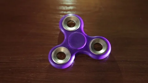 Children's toy spinner, on the table is shot close-up. Stock Footage 77708607