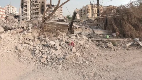 A children's toy torn on the rubble of destroyed buildings in the southern s Stock Footage 289846464