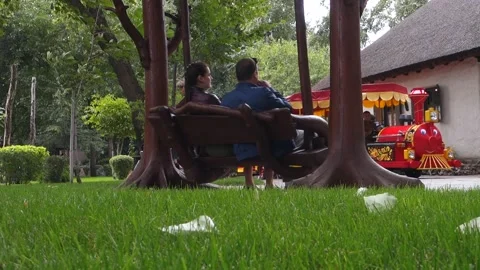 A children's train passes by a couple. Stock Footage 217291135
