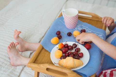 Child's breakfast on a bed Stock Photos