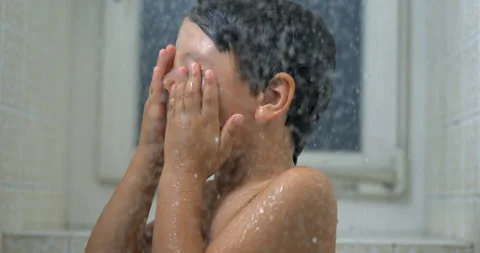 Child's Close-Up Face During Bath, Super Slow-Motion Water Droplets Flowing.. Stock Footage 250219904
