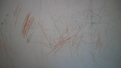 Child's creative crayon scribbles on white wall displaying artistic express.. Stock Photos