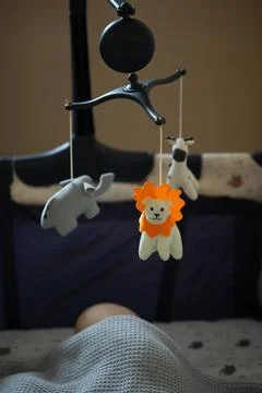 Childs Crib Mobile Features Soft Toy Animals in a Warm and Cozy Nursery Setting Stock Photos