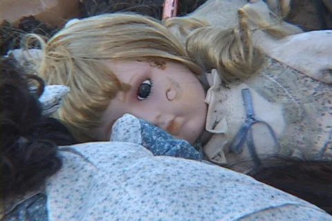 A child's doll lies in the rubble of a house after Hurricane Katrina. Stock Footage
