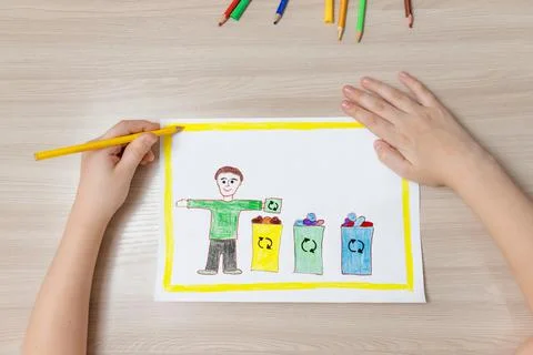 Child's drawing of garbage sorting, boy is holding a recycling sign Foto stock