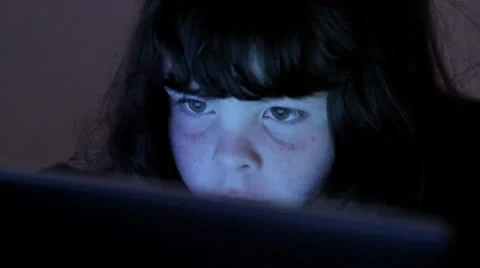 Child's face lit by computer screen, browsing Video stock 22497951