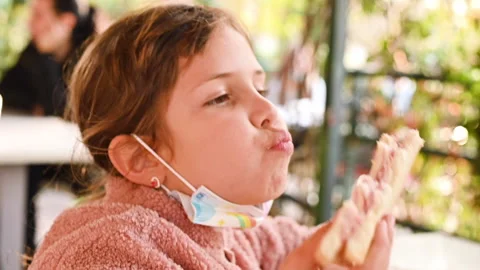 Child's face with white bread sandwich close-up. The focus on the sandwich is ch Video stock 143077499