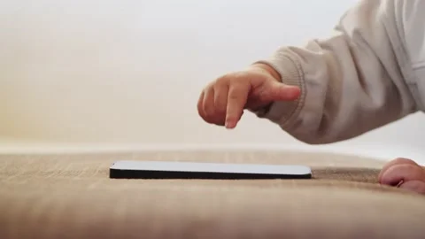 Child's finger pressing, scrolling, tapping on  mobile phone screen. Stock Footage 231531366