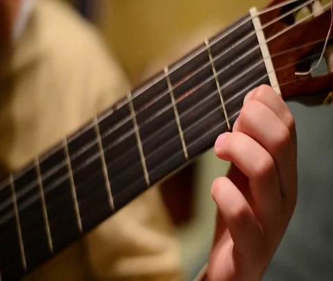 Child's hand and guitar2 Stock Footage