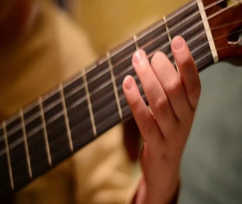Child's hand and guitar3 Stock Footage