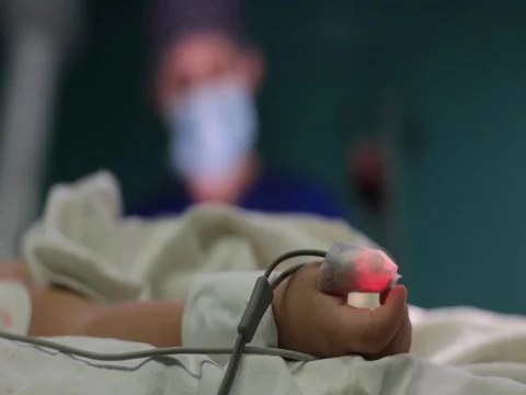 The child's hand close-up on the operating table unconscious Stock Footage 70810105