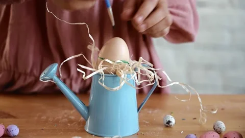 Child's hand coloring easter eggs in green color at home. Top view. Preparation Stock Footage 171973646