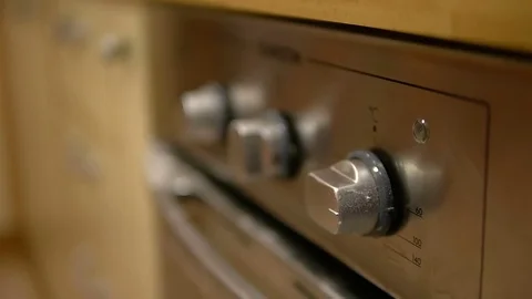 Child's hand includes an electric or gas oven at full power Stock Footage 73119123