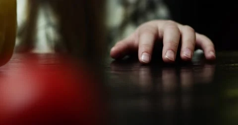The child's hand knocks nervously on table the foreground a tomato out of focus Stock Footage 152943149