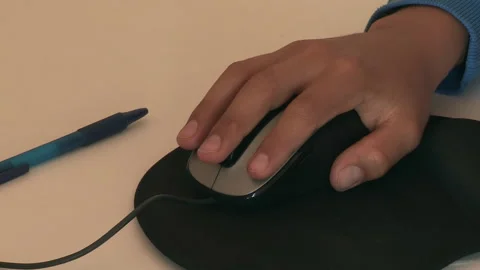 Child's hand moving a computer mouse Stock Footage 237904590