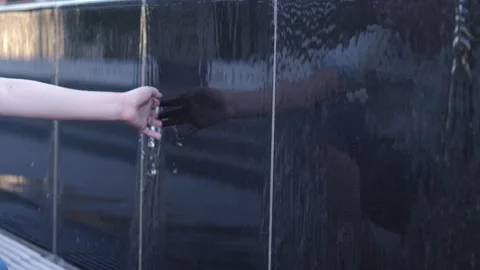 Child's hand moving through water, grand fountain, beauty of water structure Stock Footage 283630685