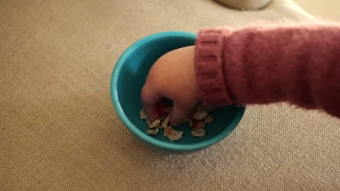 Child's hand picking up chopped dates Vídeo Stock 328471179