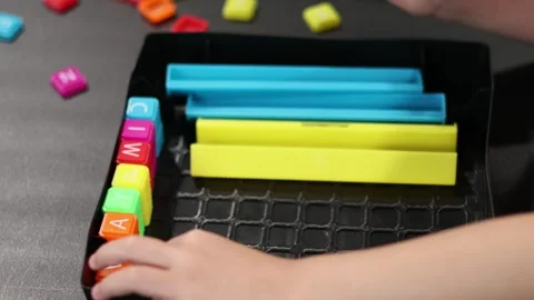 Childs hand playing with letter blocks. San Francisco CA USA May 10 2026 Stock Footage 336296062