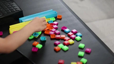Childs hand playing with letter blocks. San Francisco CA USA May 10 2026 Stock Footage 336296063