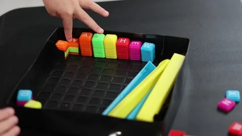 Childs hand playing with letter blocks. San Francisco CA USA May 10 2026 Stock Footage 336296068