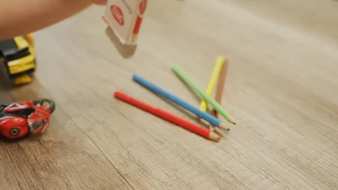 Child's hand playing with pencils Stock Footage 100000009