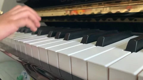 A child's hand playing the piano Stock-Footage 147247488