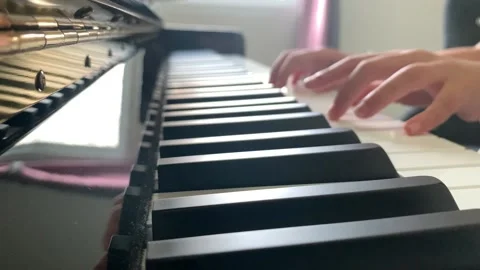 A child's hand playing the piano Stock-Footage 147247545