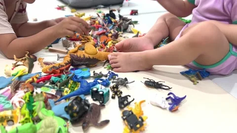 A child's hand playing with various small toys Stock-Footage 197932117