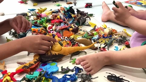 A child's hand playing with various small toys Stock-Footage 197932516