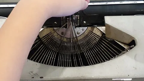 Child's hand reposition the stuck typewriter keys or stuck typing machine keys Stock Footage 279295009