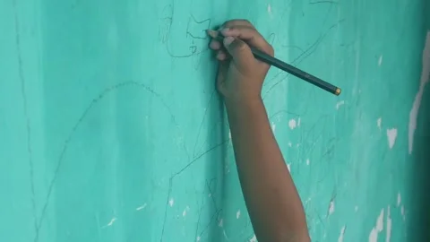 A Childs hand scribbles on a green wall Video stock 324941372
