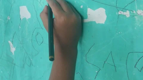 A Childs hand scribbles on a green wall Stock Footage 324941378