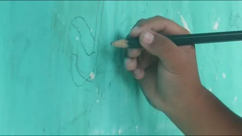 A Childs hand scribbles on a green wall Video stock 324941391