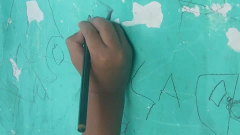 A Childs hand scribbles on a green wall Stock Footage 324941395
