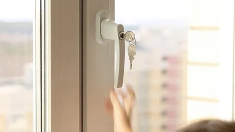 Child's hand on secure window handle Video stock 75731102