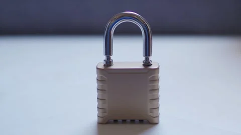 Child's hand securing combination padlock for data protection Stock Footage 341416219